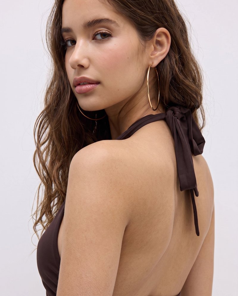 Model wearing gold hoop earrings, variation 1